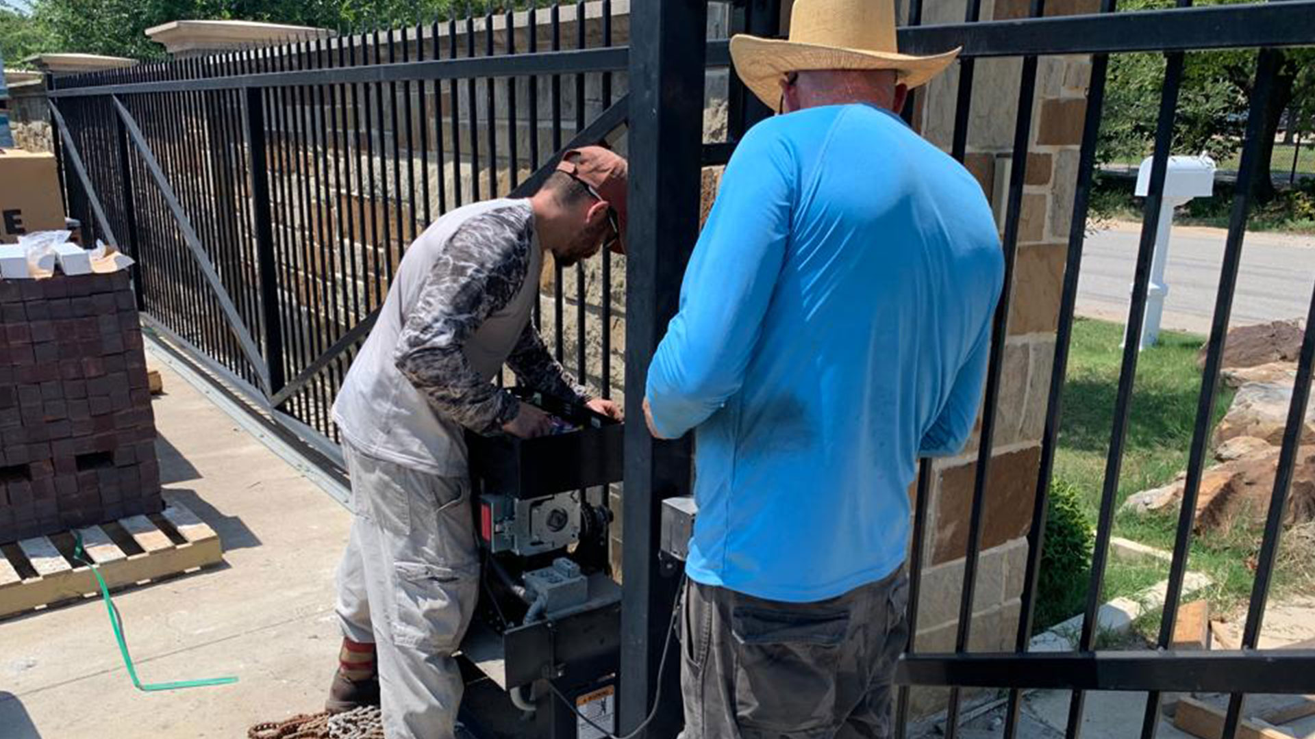 Technicians servicing an electric gate operator in Coppell, TX – Coppell garage door repair and gate service Technicians servicing an electric gate operator in Coppell, TX – Coppell garage door repair and gate service