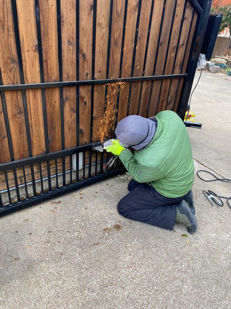 GarageTec technician repairing an automatic gate