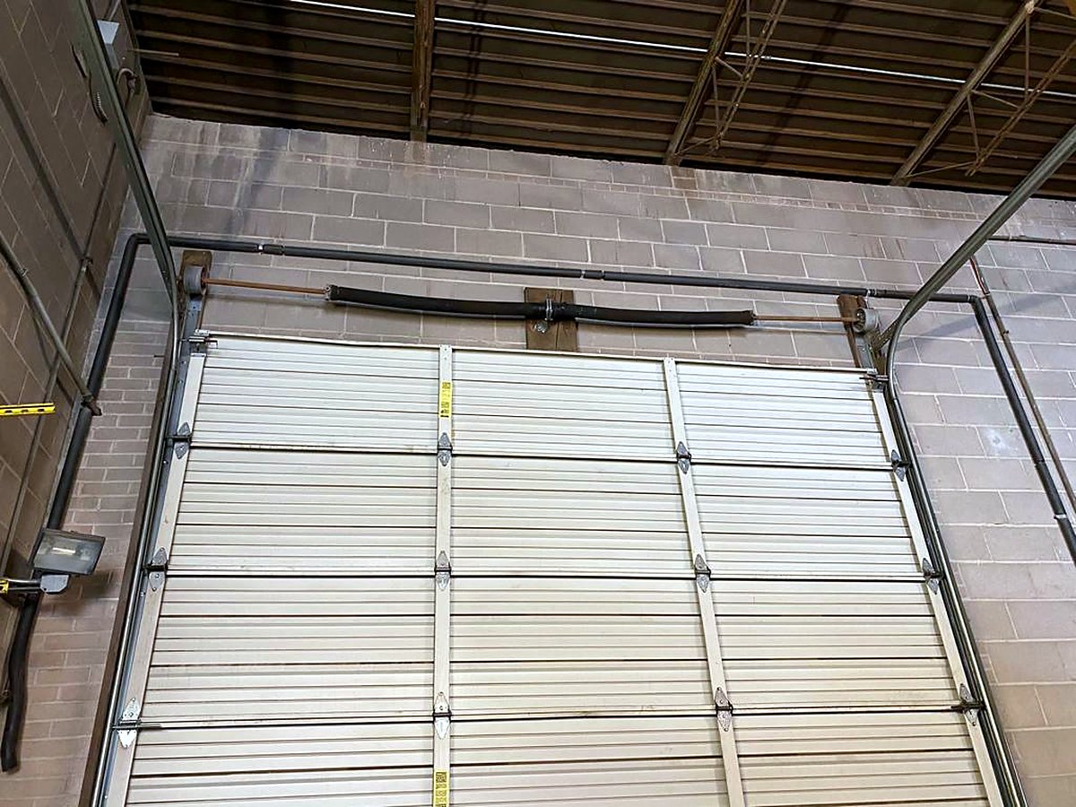 Commercial sectional door installed in a block-wall building Commercial sectional door installed in a block-wall building