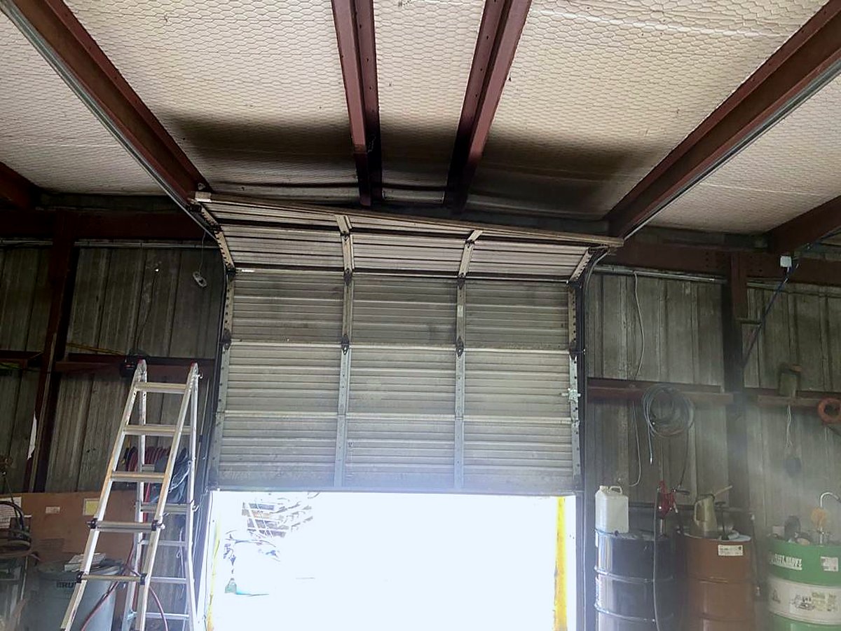 Garage Tec technician servicing a commercial door operator