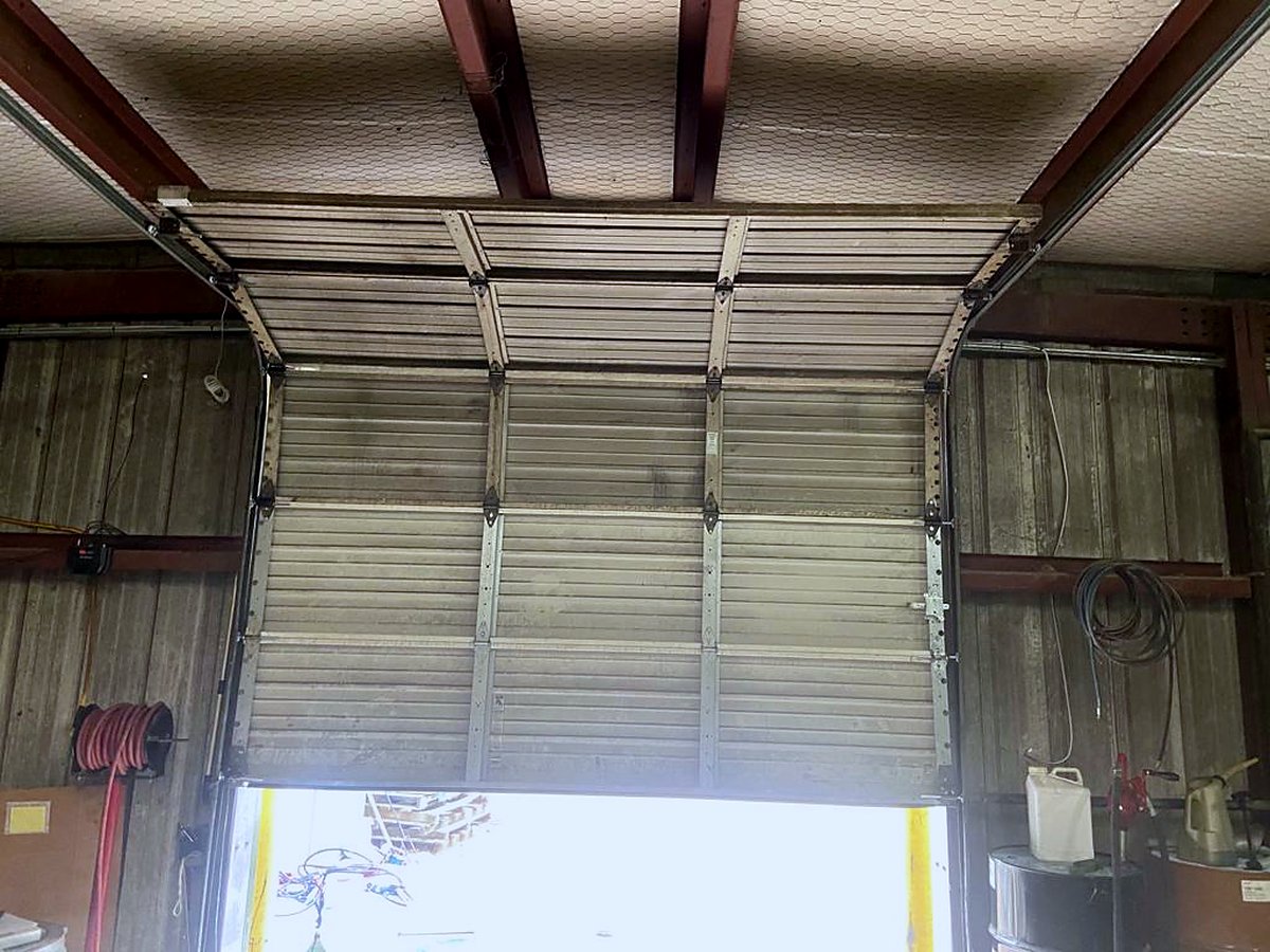 Commercial sectional steel door open on a warehouse bay
