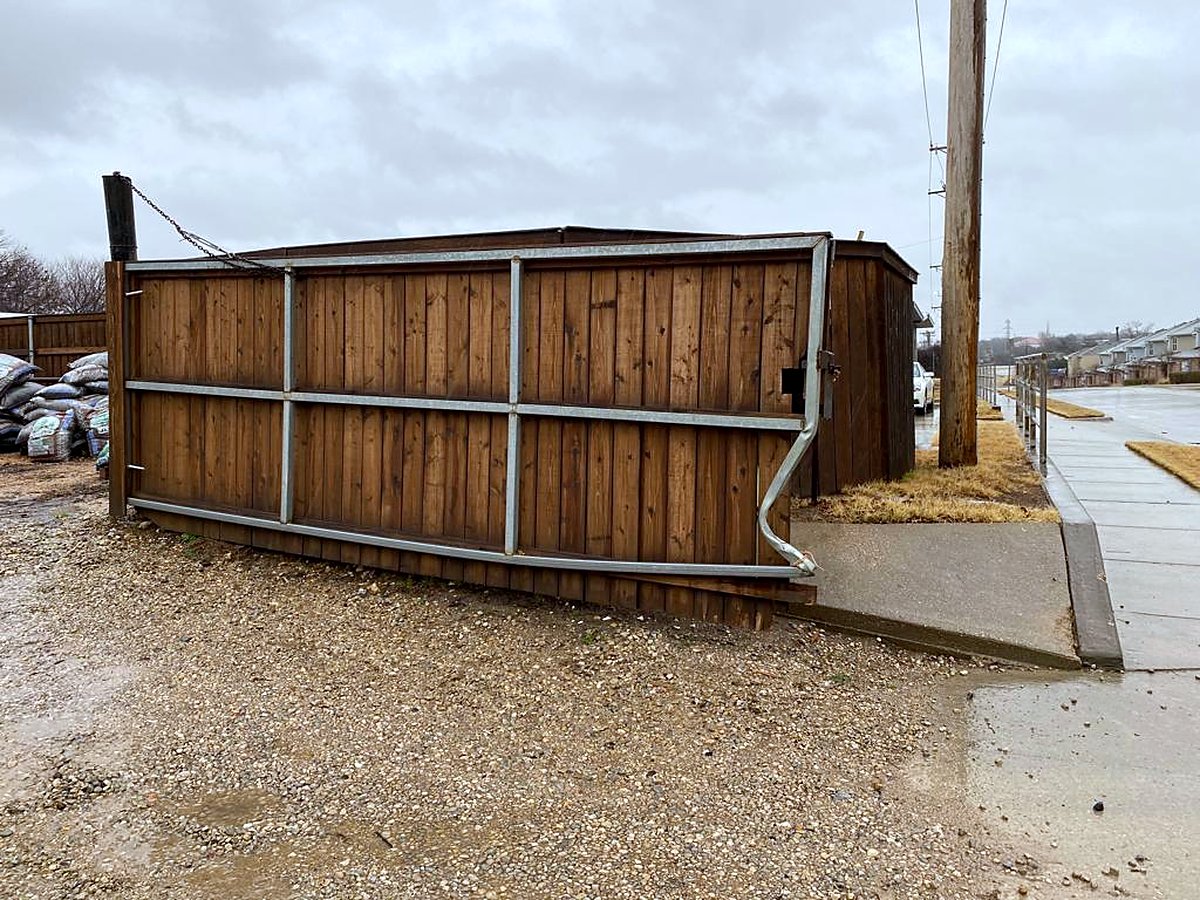 Wooden sliding gate collapsed off its track before repair
