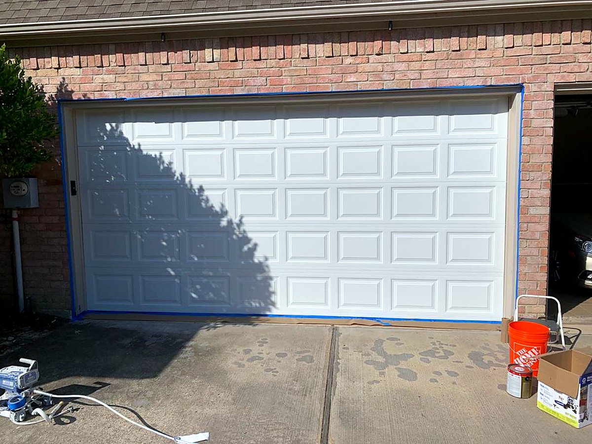 Garage Tec technician finishing a new garage door installation Garage Tec technician finishing a new garage door installation
