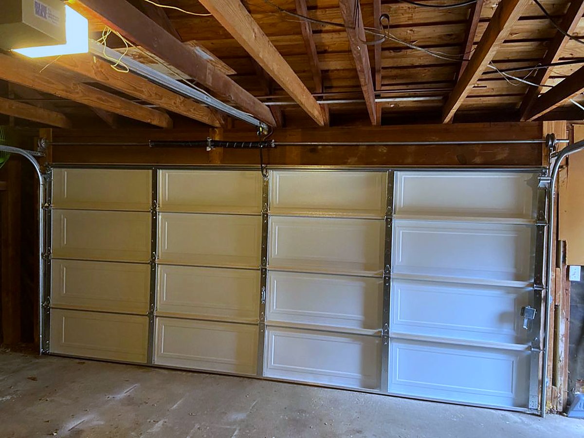 Newly installed insulated garage door viewed from inside the garage Newly installed insulated garage door viewed from inside the garage